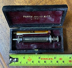 Hypodermic syringe in case