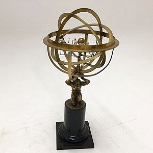Armillary sphere on decorative stand.