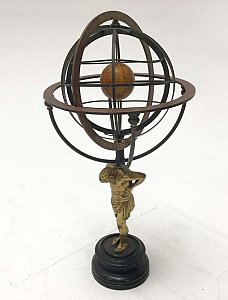 Armillary sphere on decorative stand.