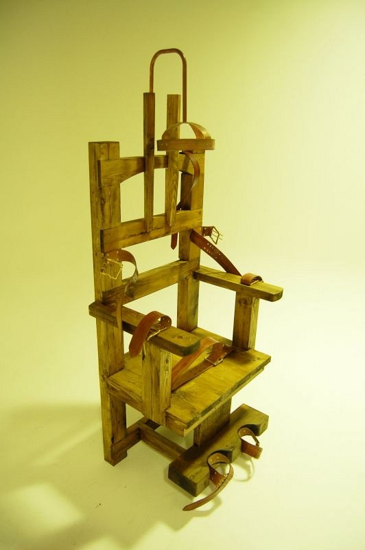 Wooden electric chair with leather restraining straps